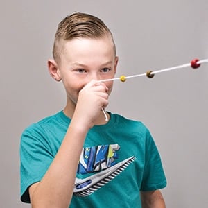 A concussion patient holding a Brock string to his nose