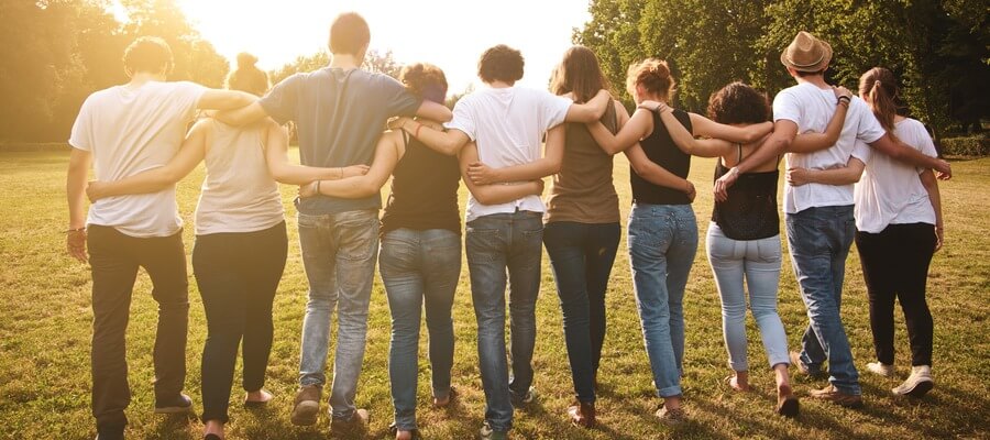 Row of people with arms around each other