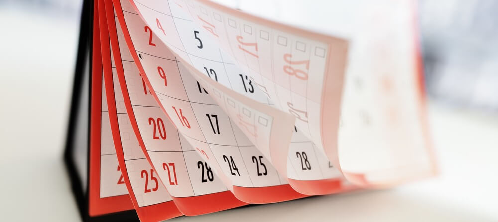 Pages of a calendar in motion.