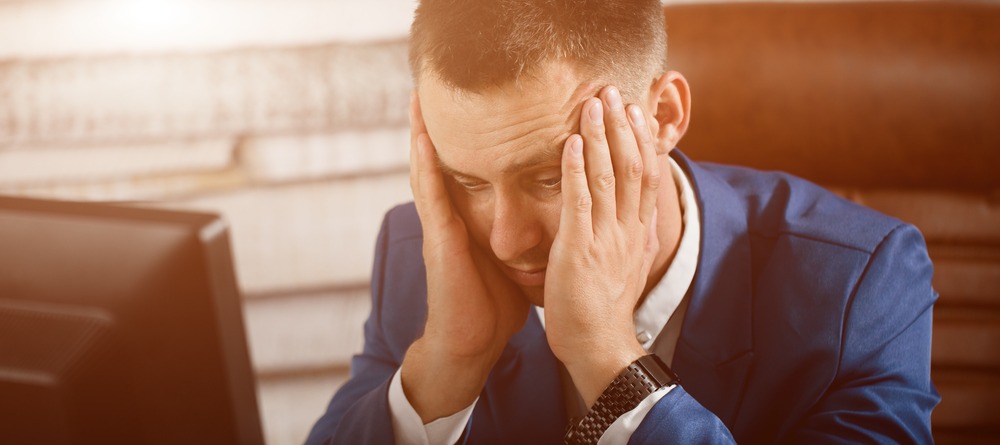 Man holding temples in pain