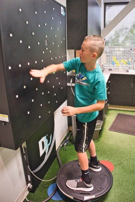 A young man uses the Dynavision board. 