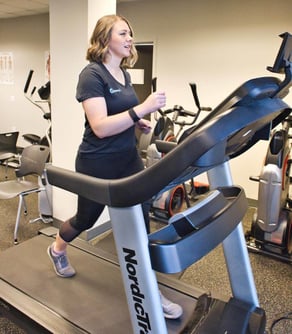 A patient exercises on a treadmill. 