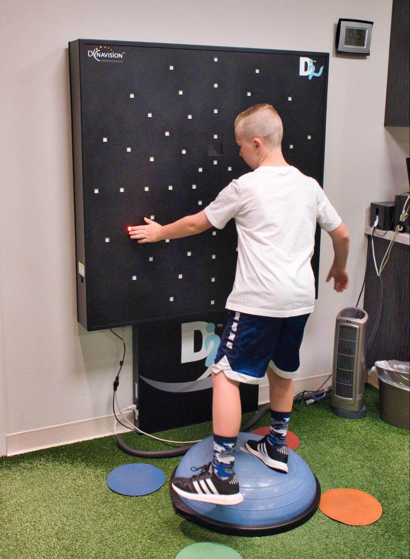 A young man demonstrates a Bosu ball activity. 