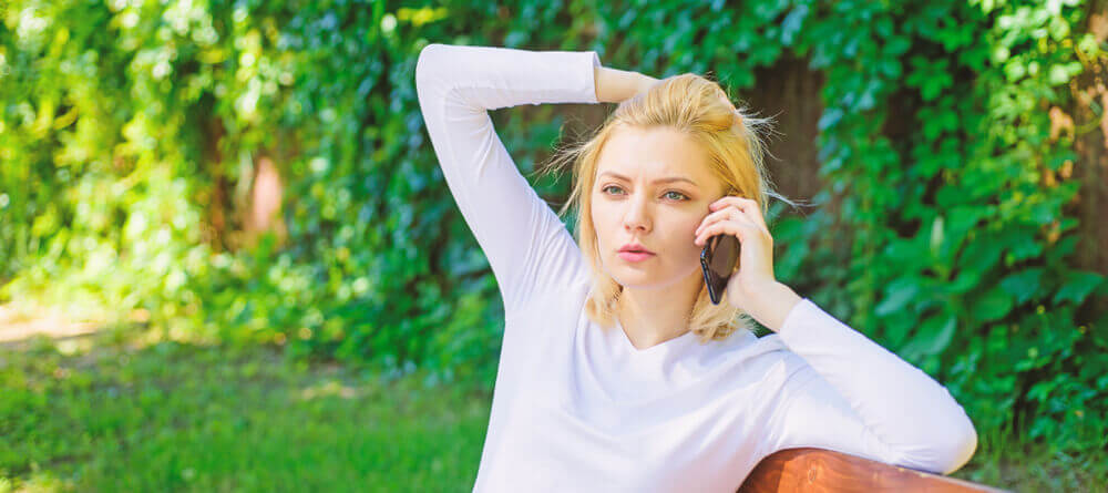 Image of a women talking on her phone looking confused