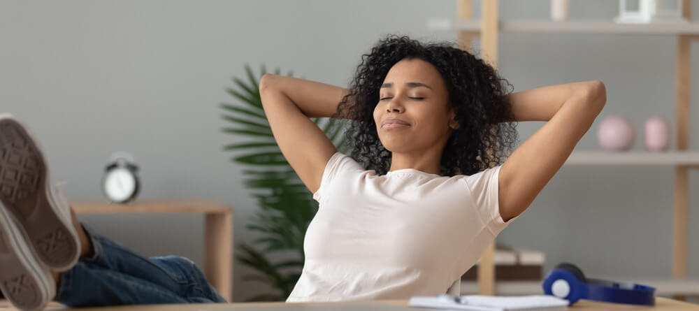 A women taking a break by daydreaming with her eyes closed. 