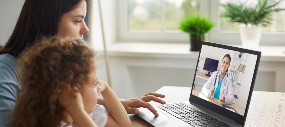 Mother and daughter meeting with a doctor over a video call. 