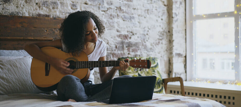 Image of a women playing a guitar