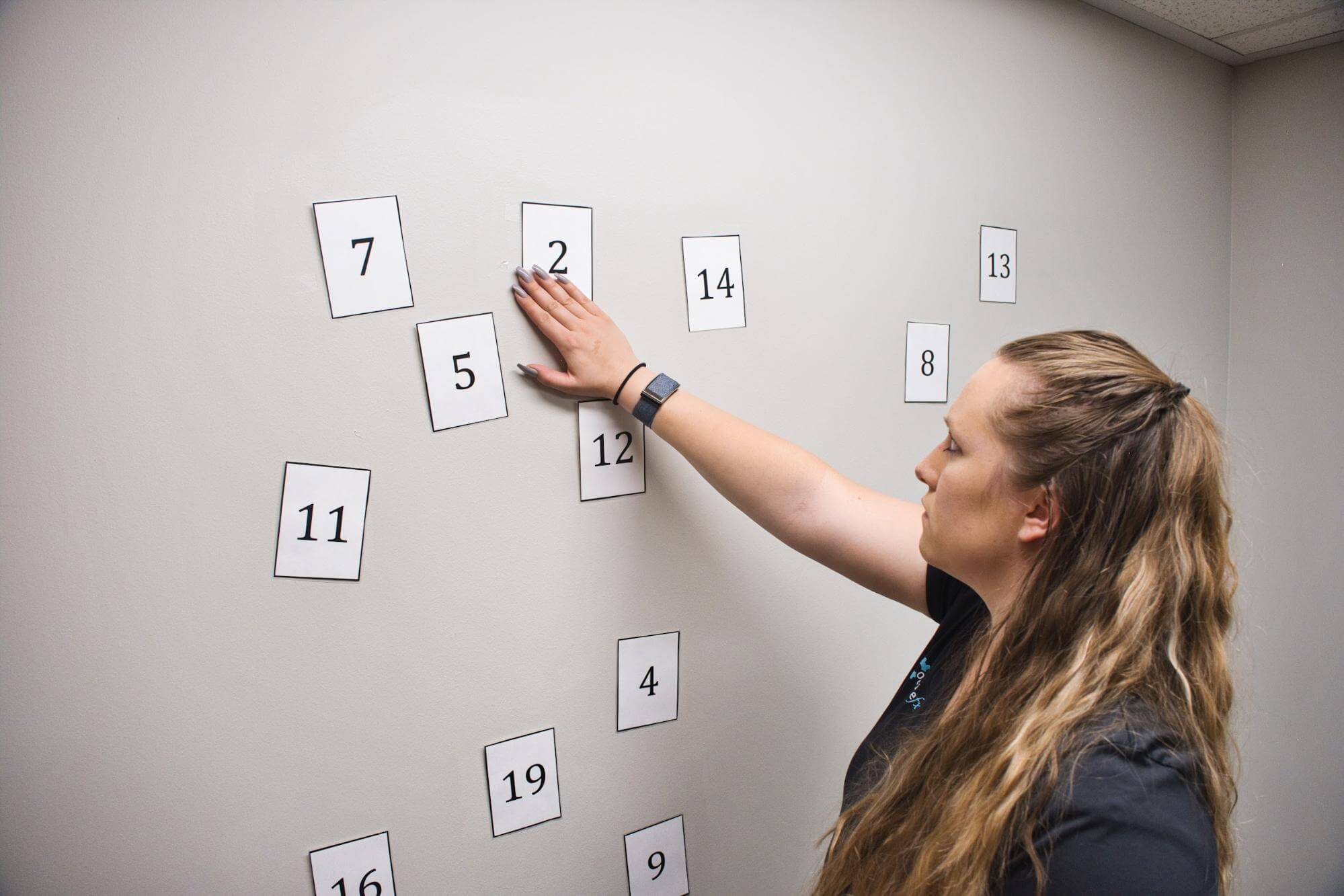 A therapist demonstrates a therapy game to do at home. 