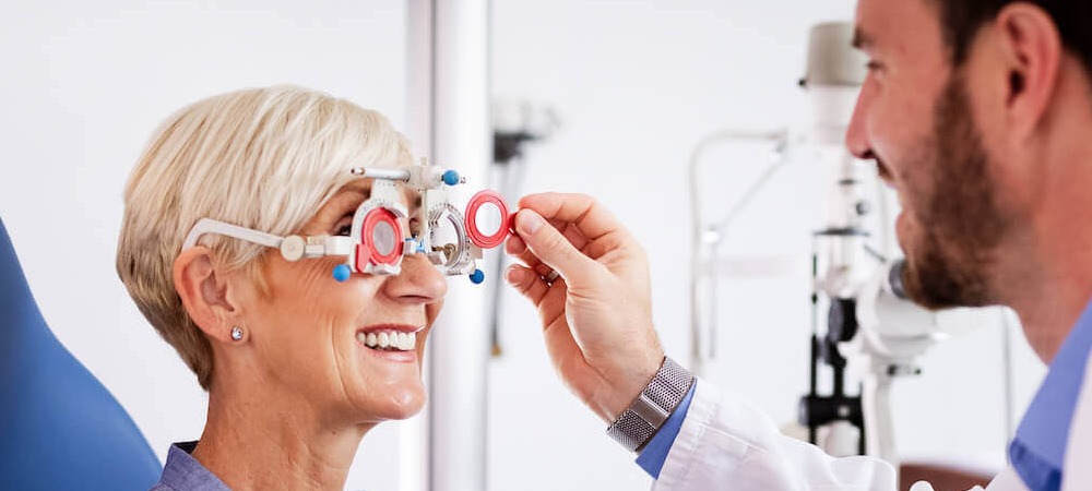 A doctor checks a women's vision.