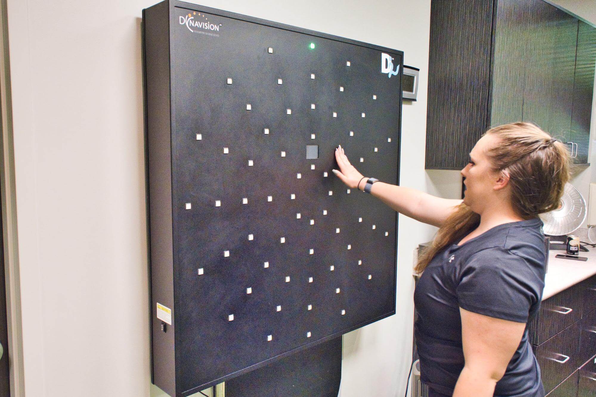 Therapist demonstrates how to use Dynavision board. 