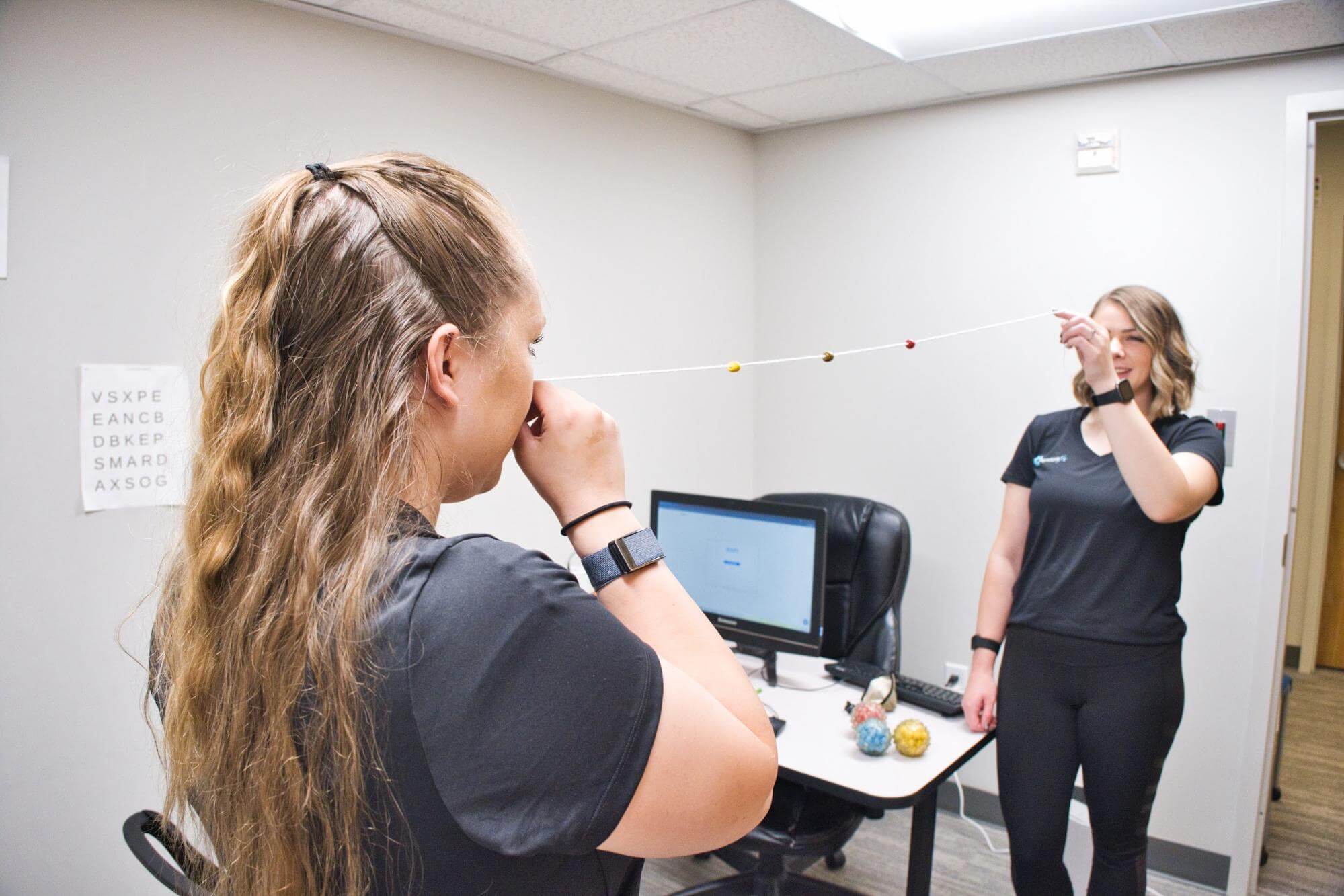 Therapists demonstrate how to use a Brock string.