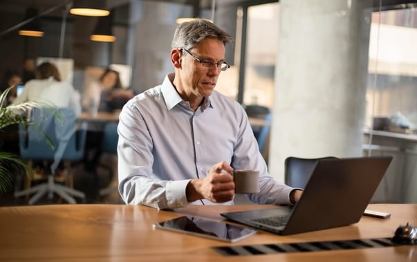 A businessman is working on his computer at the office