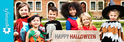 children dressed up holding a happy halloween sign