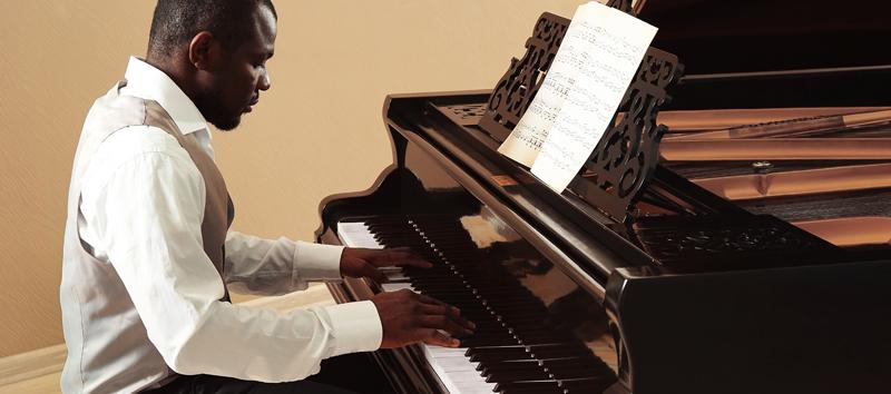 A photo of a man playing the piano. 