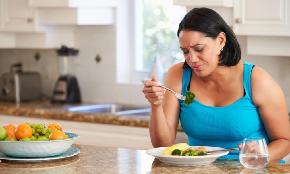 A woman is eating her lunch.