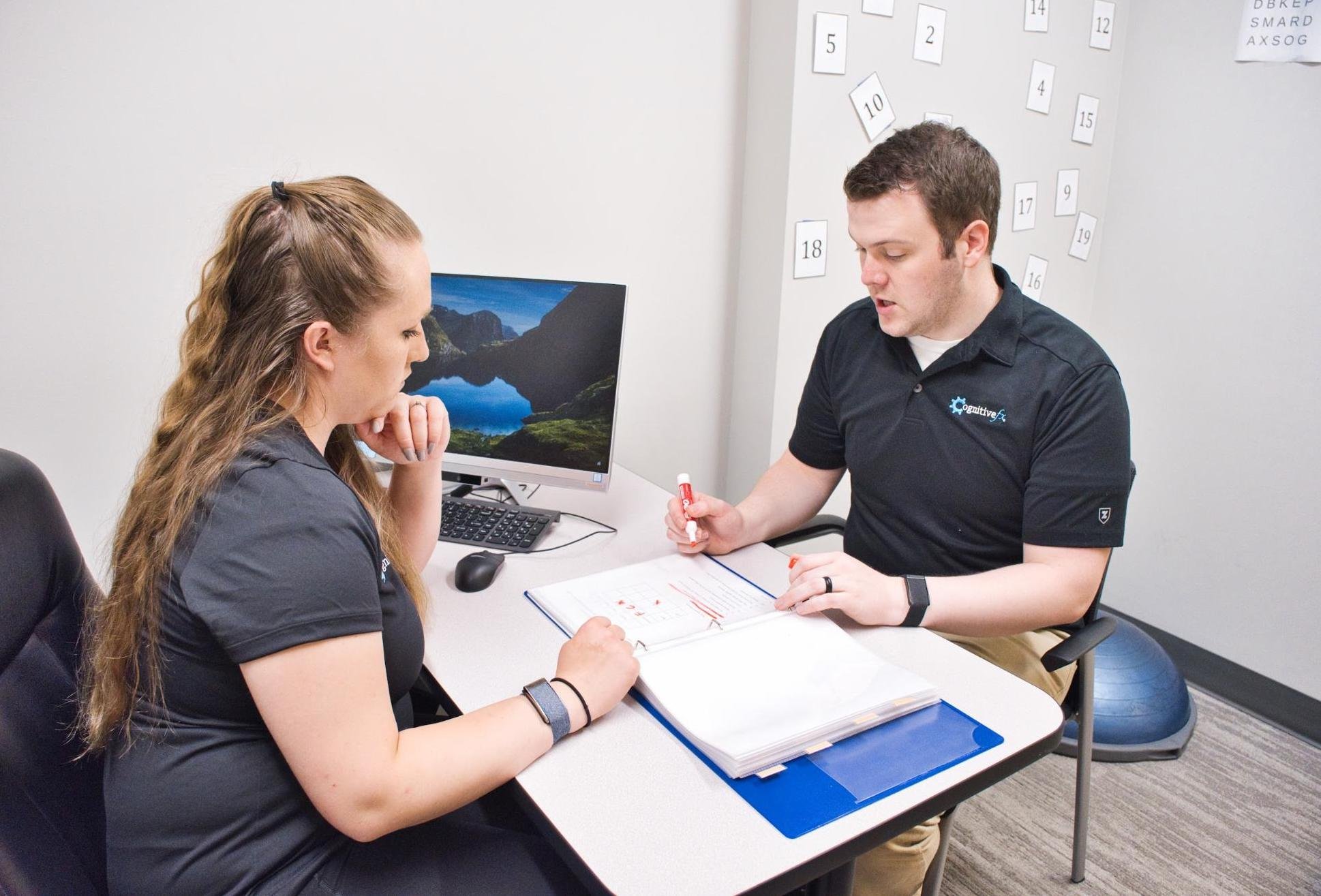 Cognitive FX Staff going over a treatment plan for one of their clients.