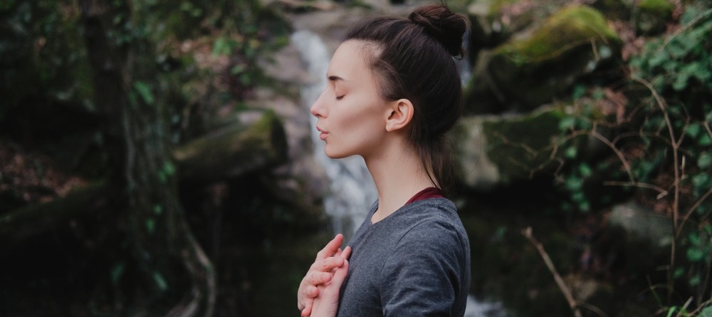 A woman practicing breathing techniques.