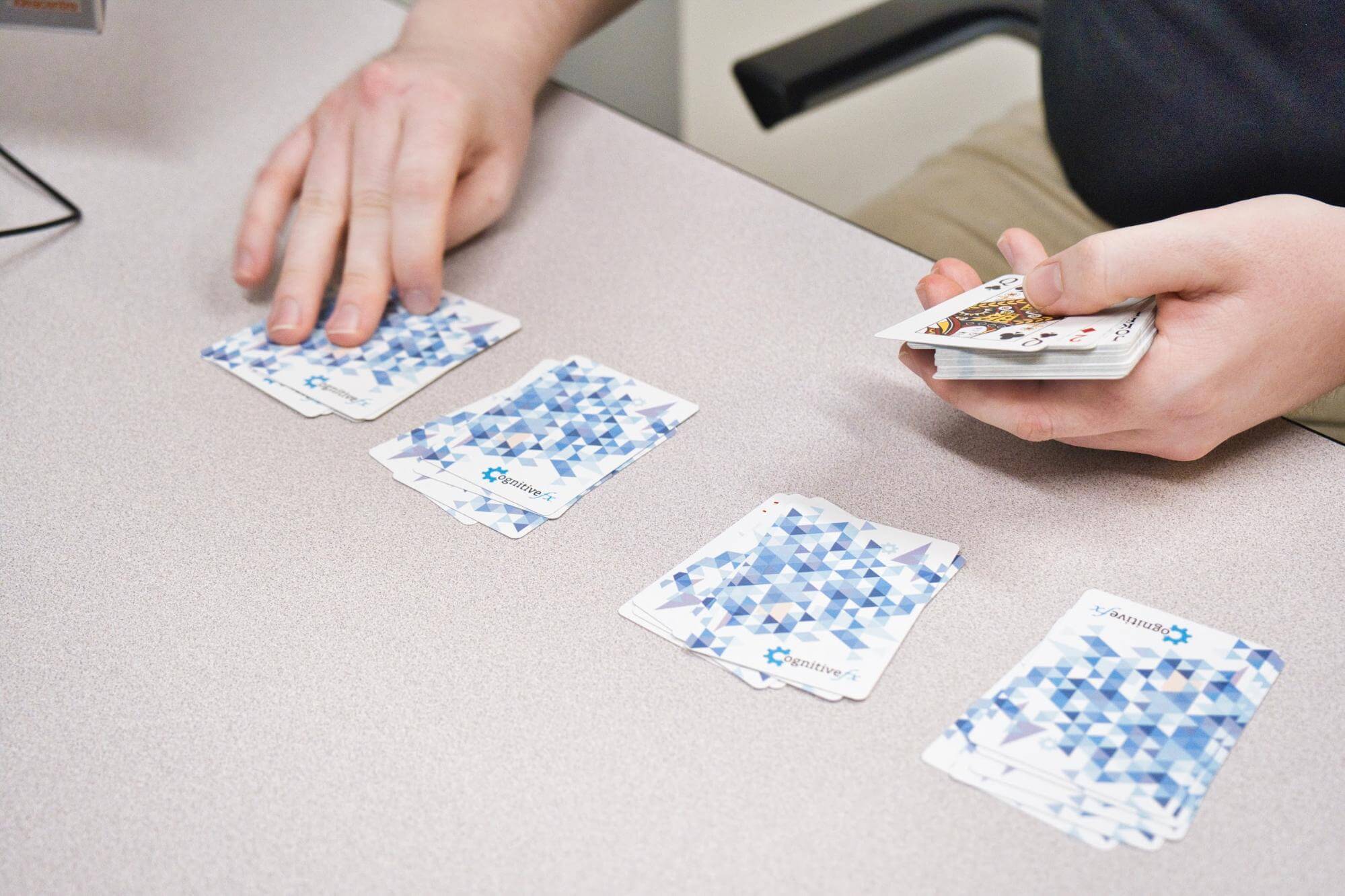 Patient demonstrates a card game for treatment. 