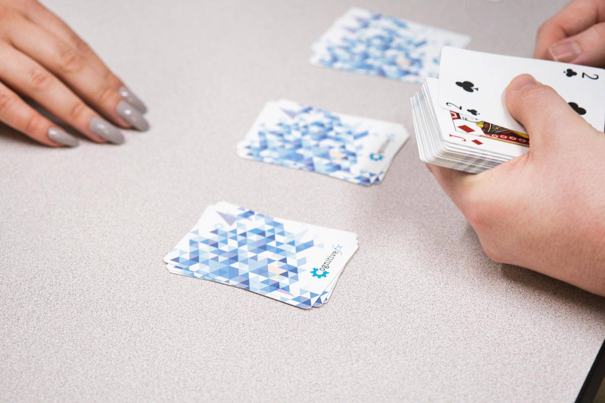A patient sorts cards face side down during treatment. 