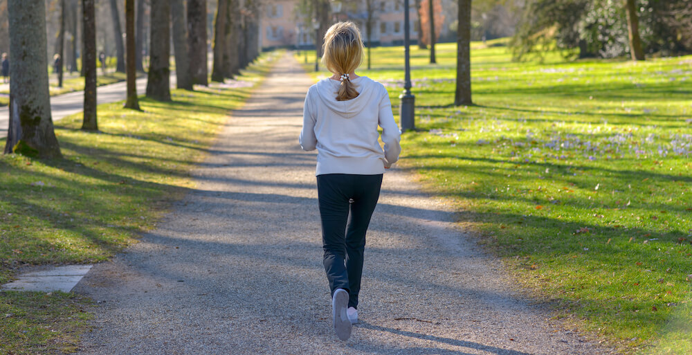 A woman is on a jog outside.