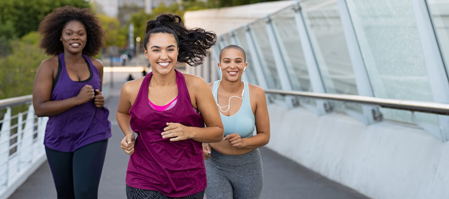 A photo of three women running together
