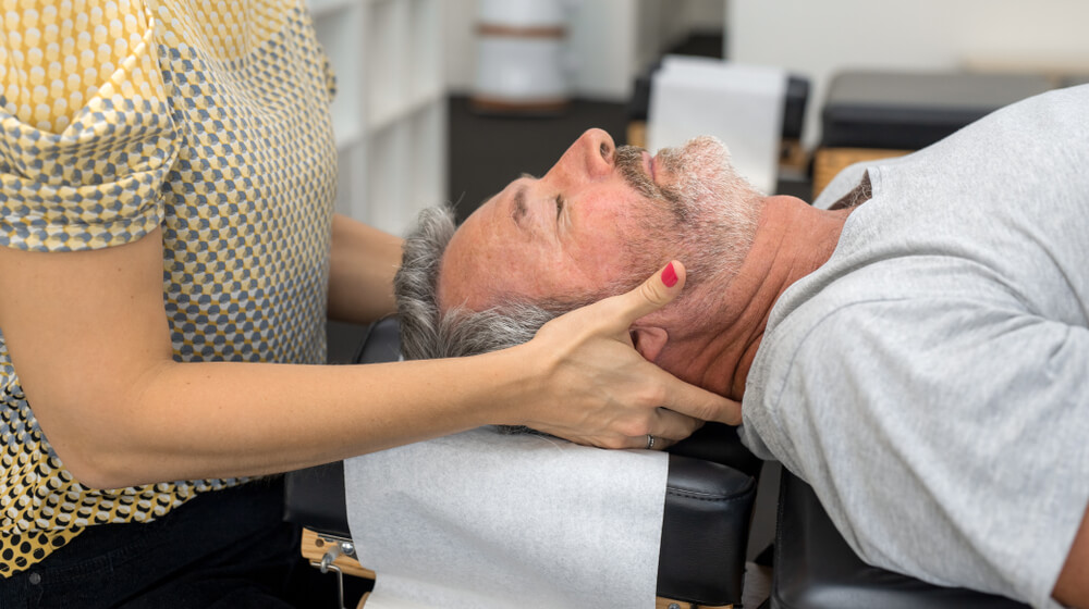 patient being adjusted by chiropractor