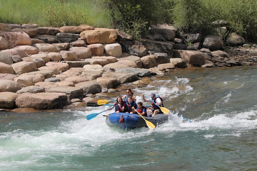 Sam whitewater rafting with his family