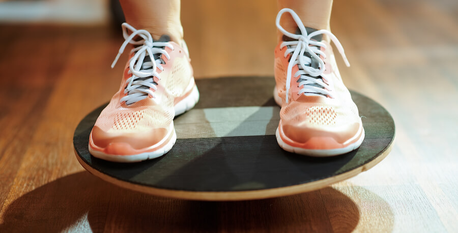 A woman balancing on a balance board.