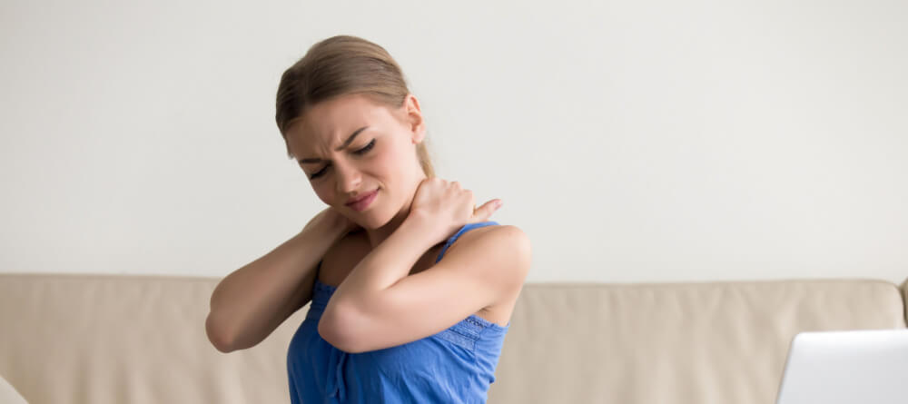 Women rubbing her neck in pain. 