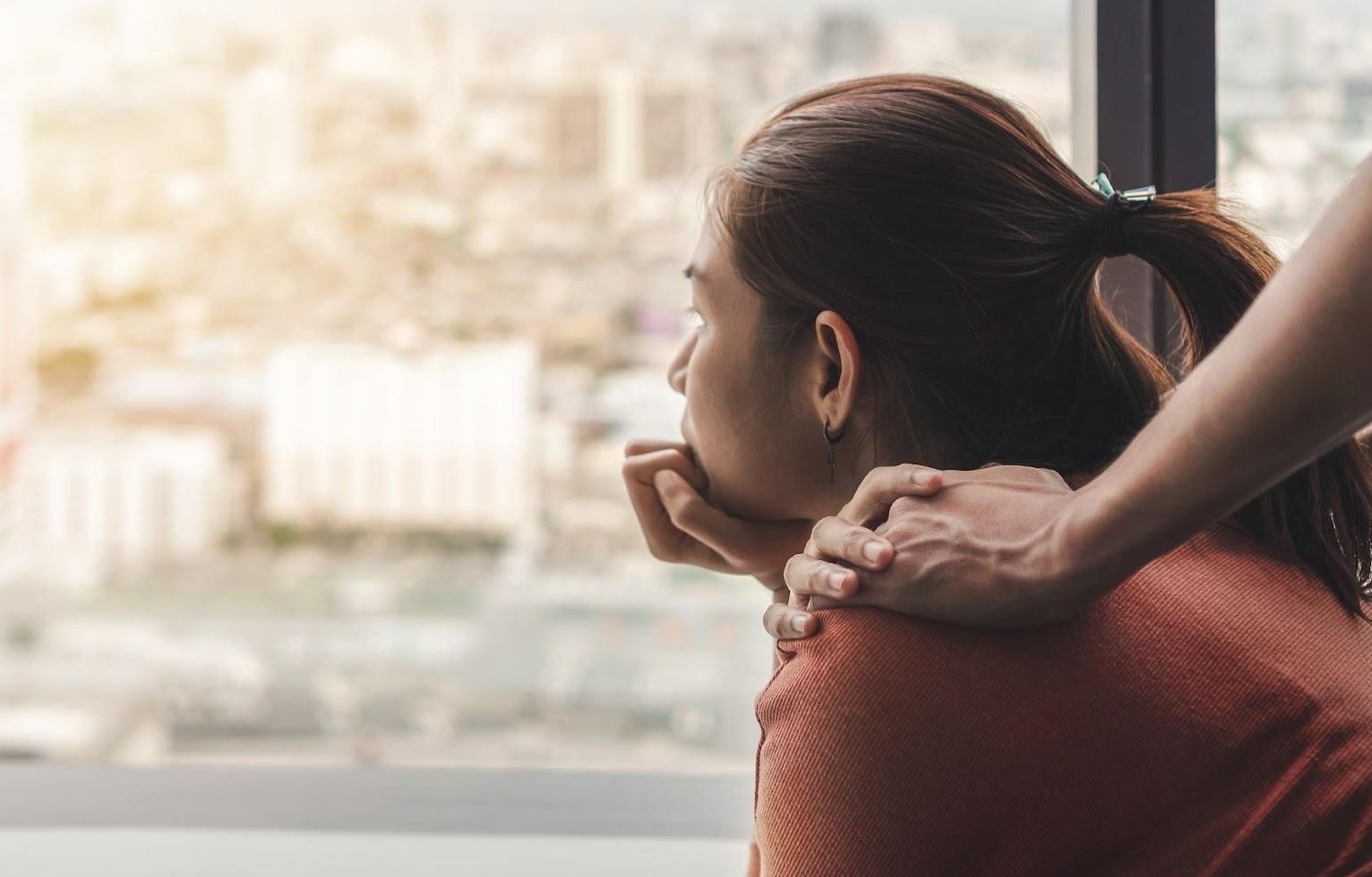 woman staring out the window