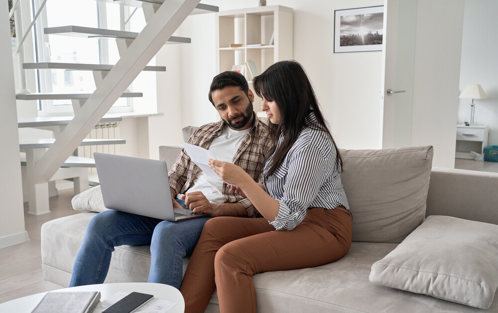 young couple looking over pricing and insurance options