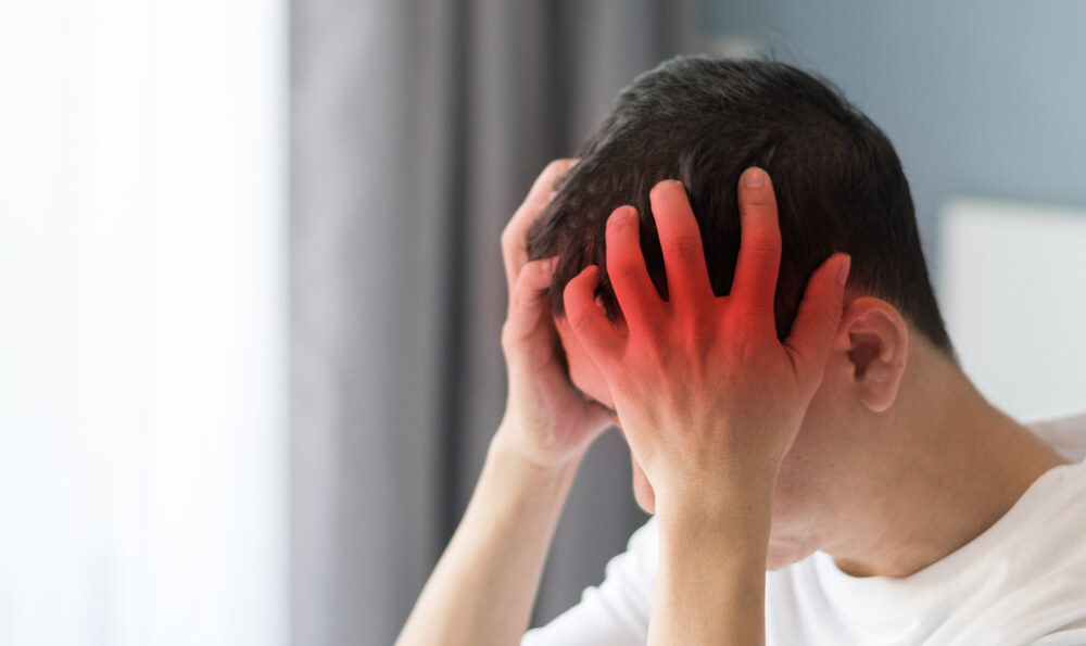 young man with head pain