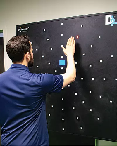 A concussion patient using a Dynavision board