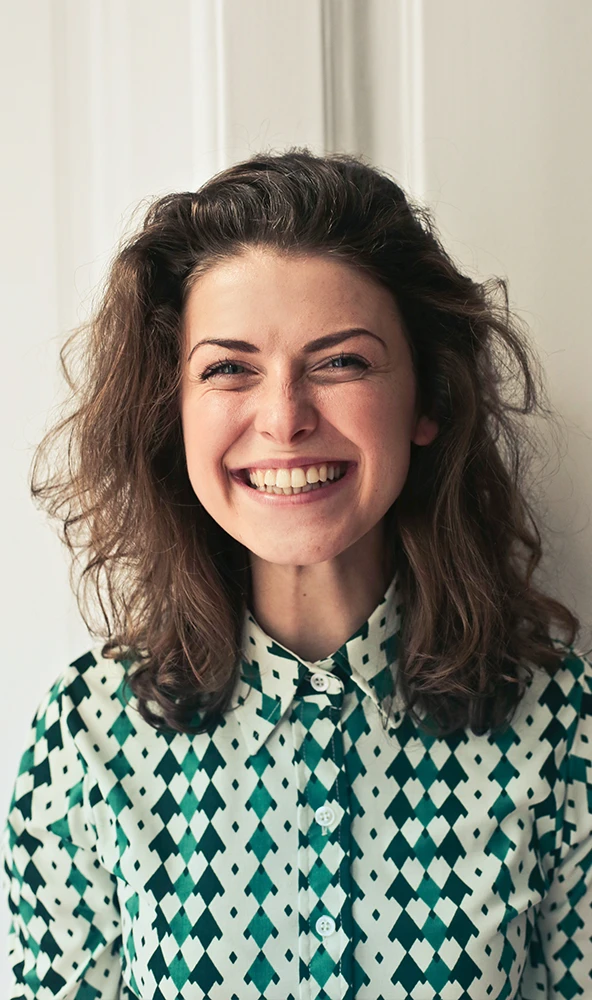 A woman is smiling with hope and joy
